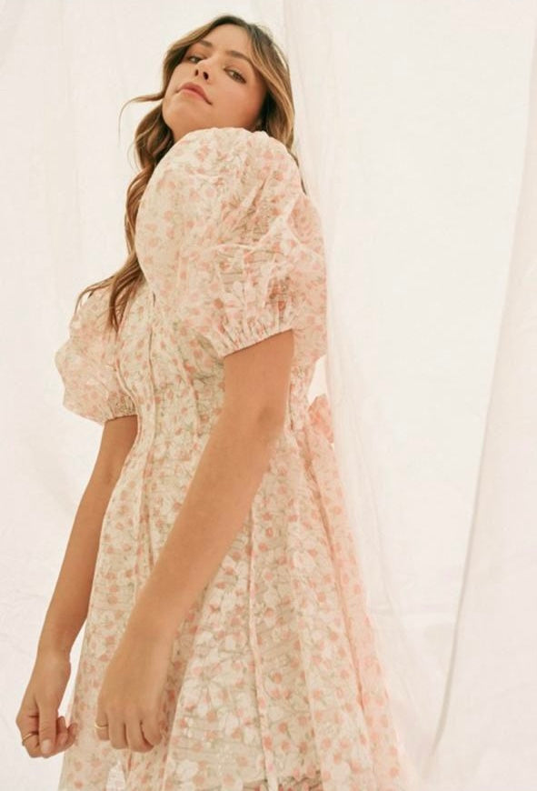 Dress with loose sleeves and a sheer cape.